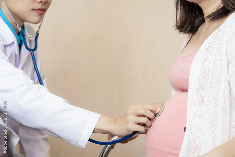 Happy pregnant woman visit gynecologist doctor at hospital or medical clinic for pregnancy consultan