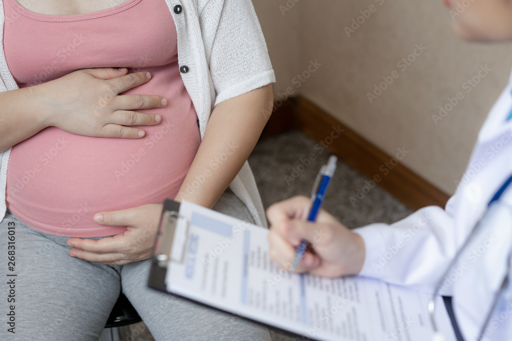 Happy pregnant woman visit gynecologist doctor at hospital or medical clinic for pregnancy consultan