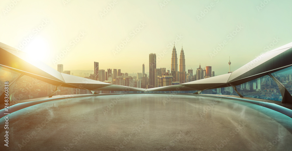 Panoramic view of futuristic geometric shapes design empty floor with city skyline . Sunset scene .