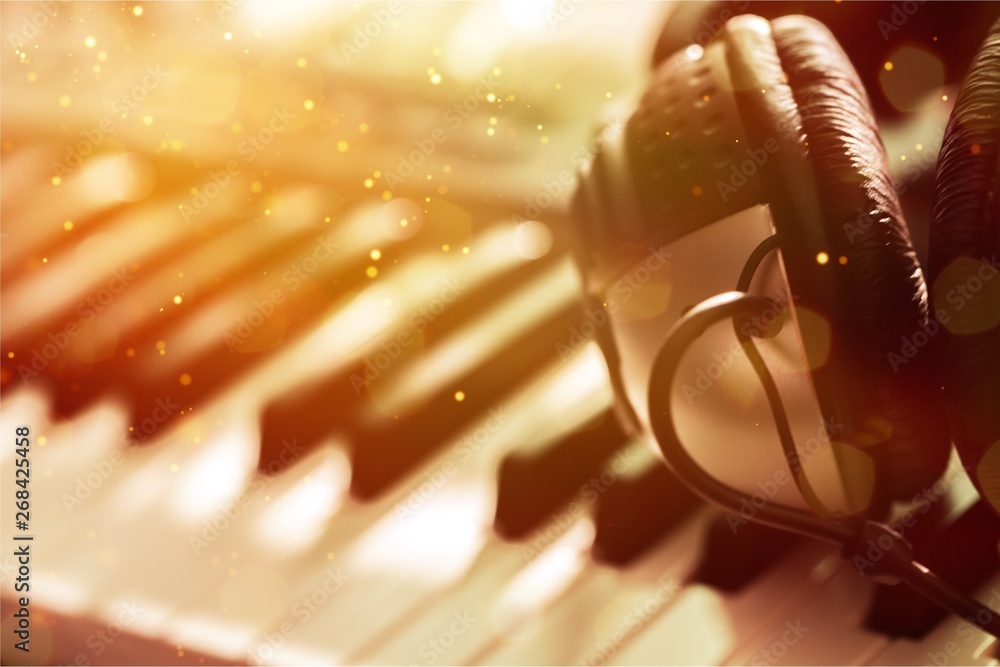 Piano keyboard with headphones, close-up