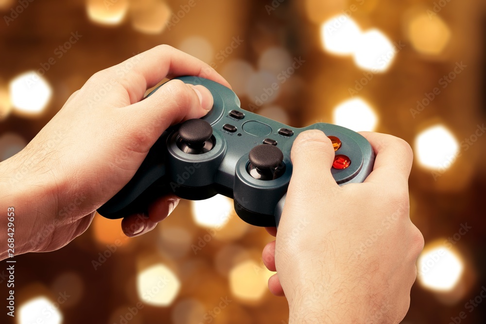 Teenage boy holding console controller