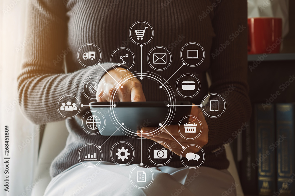  Woman using smart phone for mobile payments online shopping,omni channel,sitting on table,virtual i