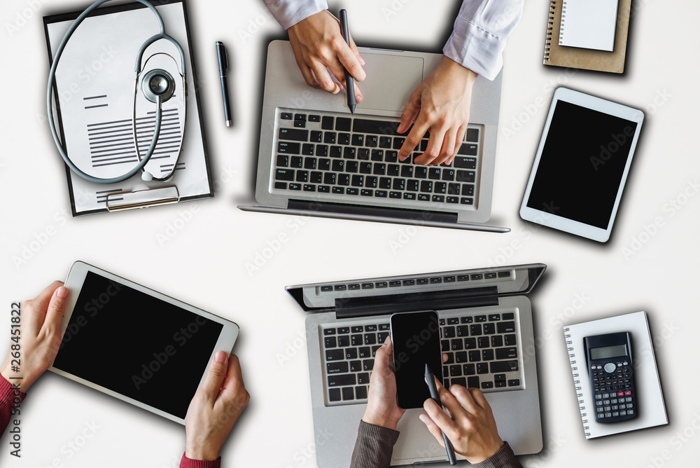 Top view of Medicine doctor hand working with modern computer and digital pro tablet circular, lapto