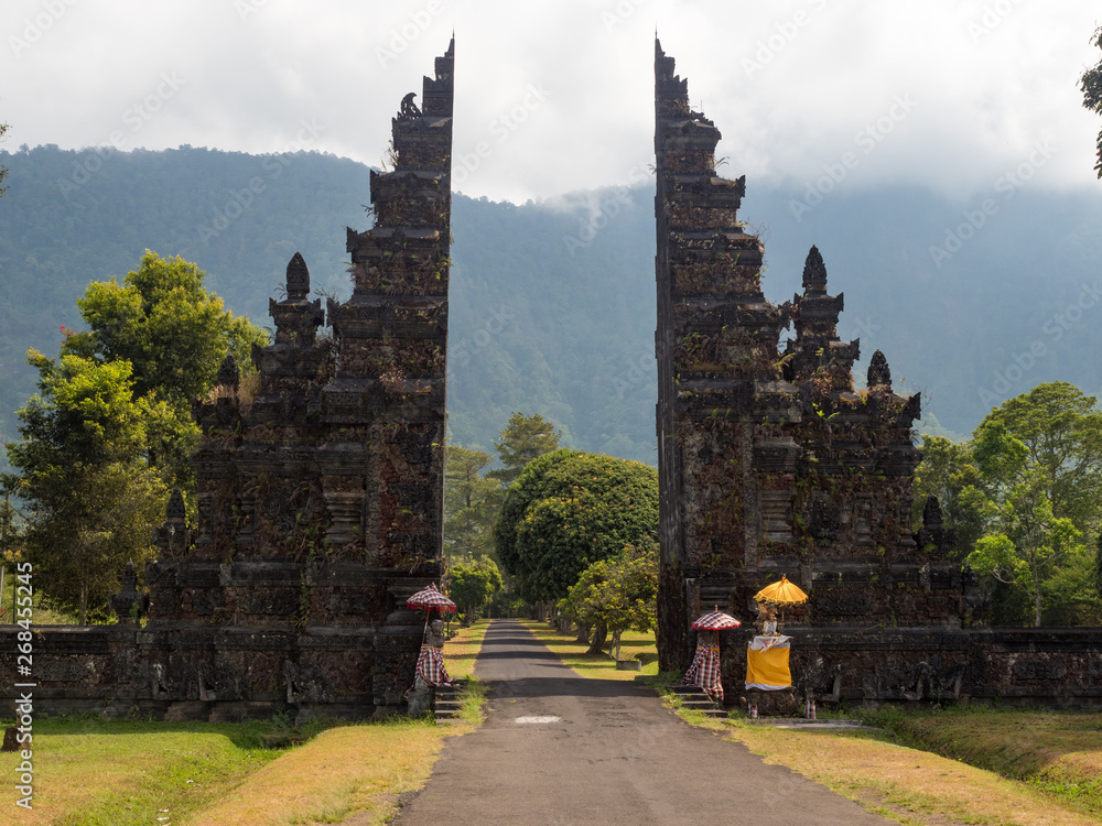 Beautiful view of ancient Handara gate in the morning with the mist over mountain in Bali, Indonesia