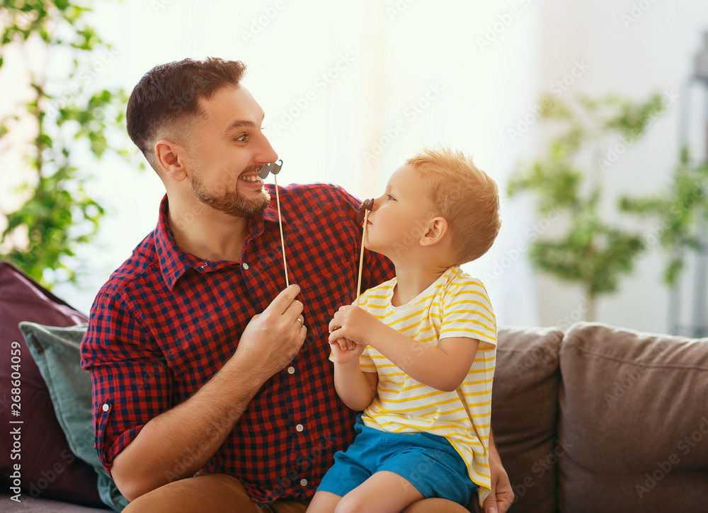 Fathers day. Happy funny family son and dad with mustache .