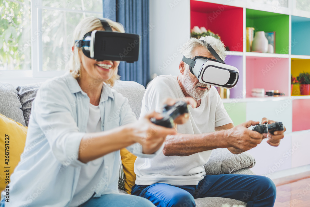 Couple senior enjoy playing VR 3D games at home