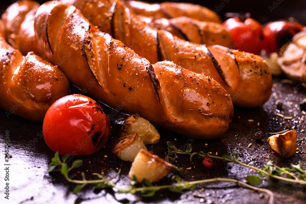 Grilled sausages and various vegetables  in iron plate