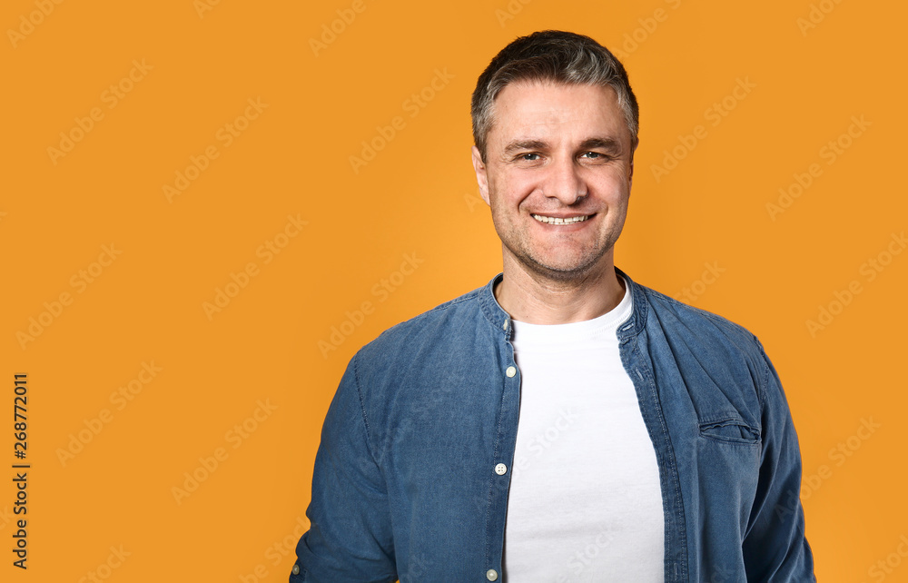 Portrait of handsome mature man on color background