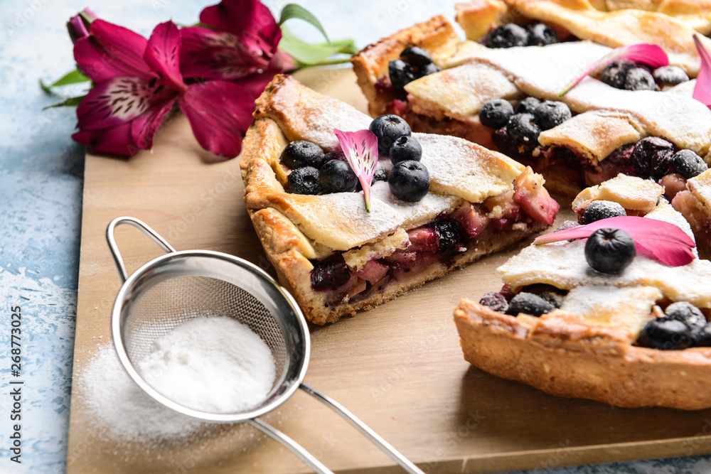 Tasty blueberry pie on table