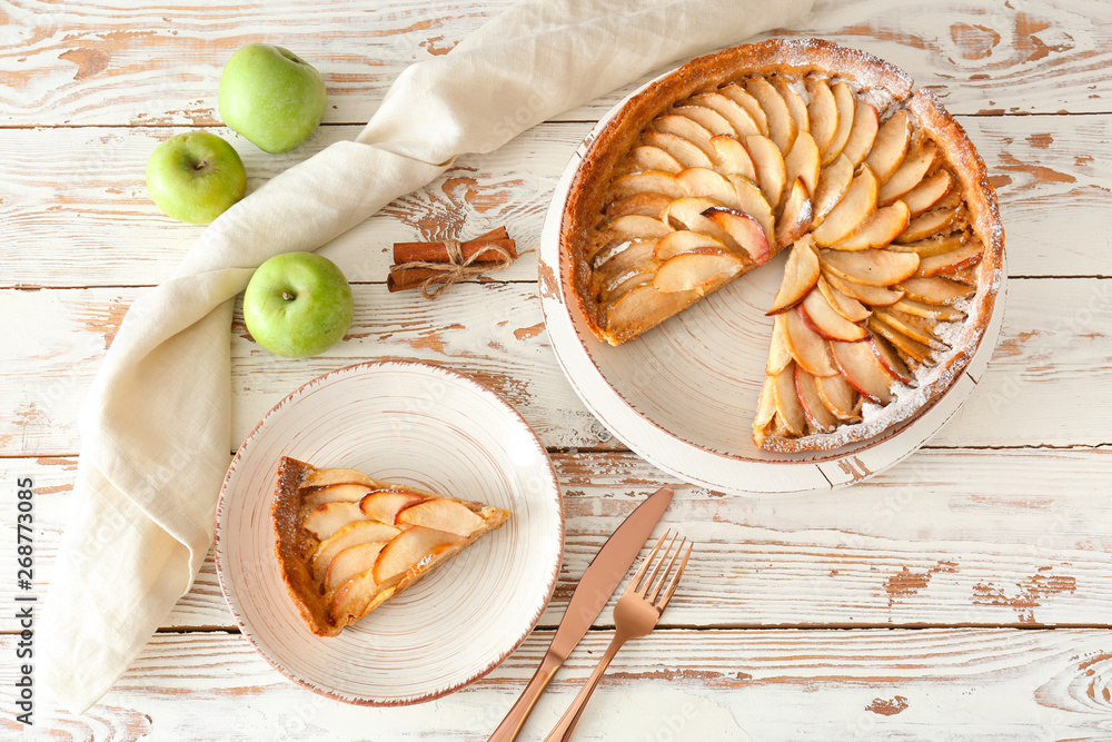 Tasty apple pie on white wooden table