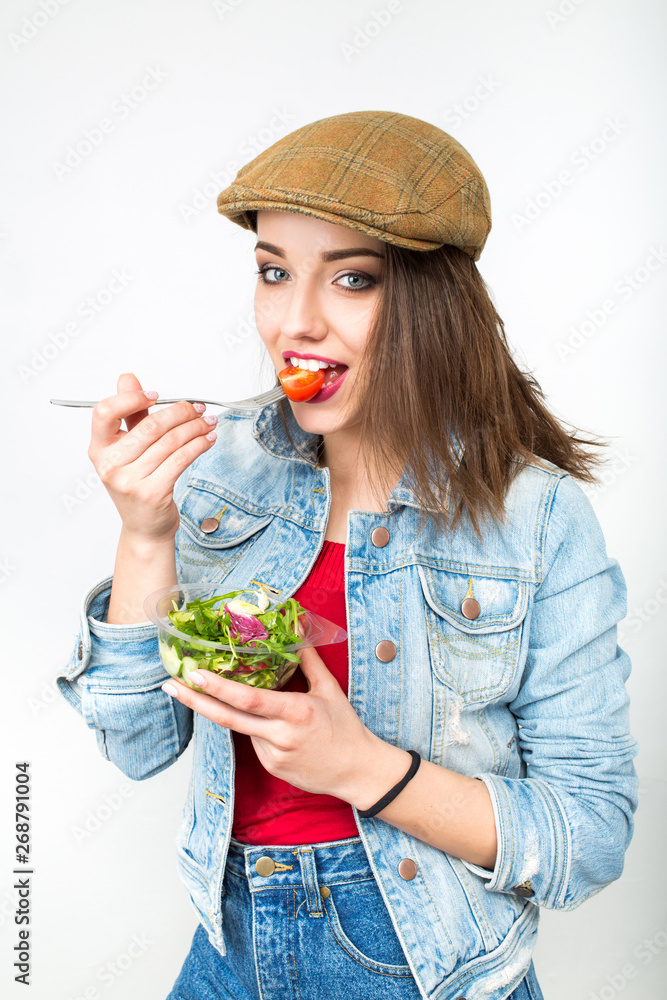 Portrait of attractive caucasian smiling woman eating salad