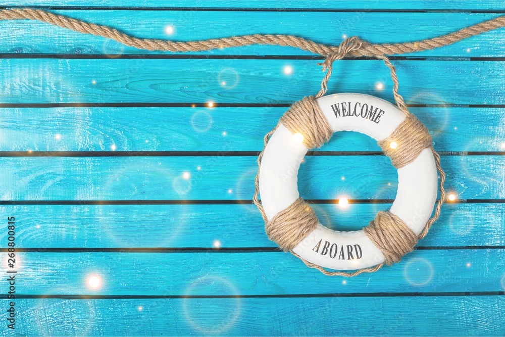 Lifebuoy on blue wooden background with place for text