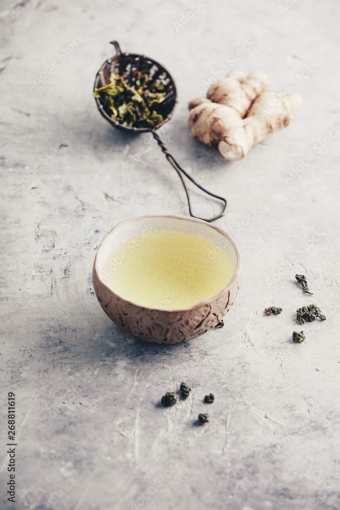 Tea composition with old chinese cups of green tea and white teapot