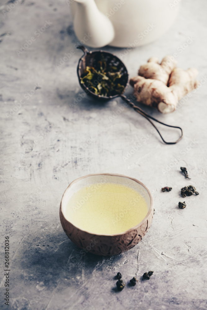 Tea composition with old chinese cups of green tea and white teapot