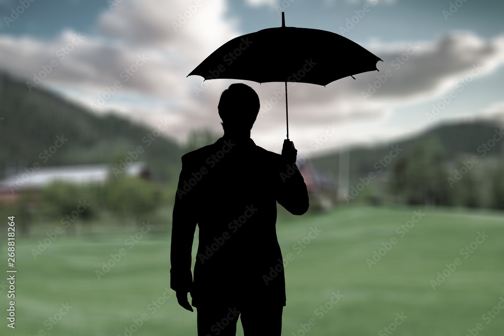 Portrait of  businessman with umbrella on background