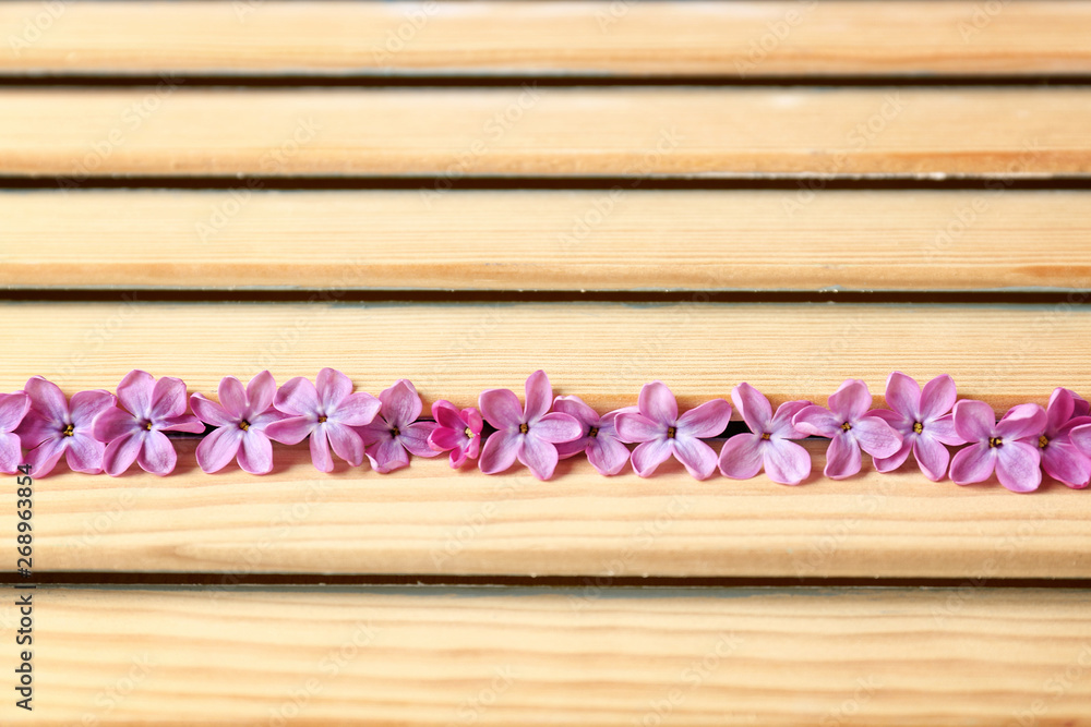 Beautiful lilac flowers on wooden background