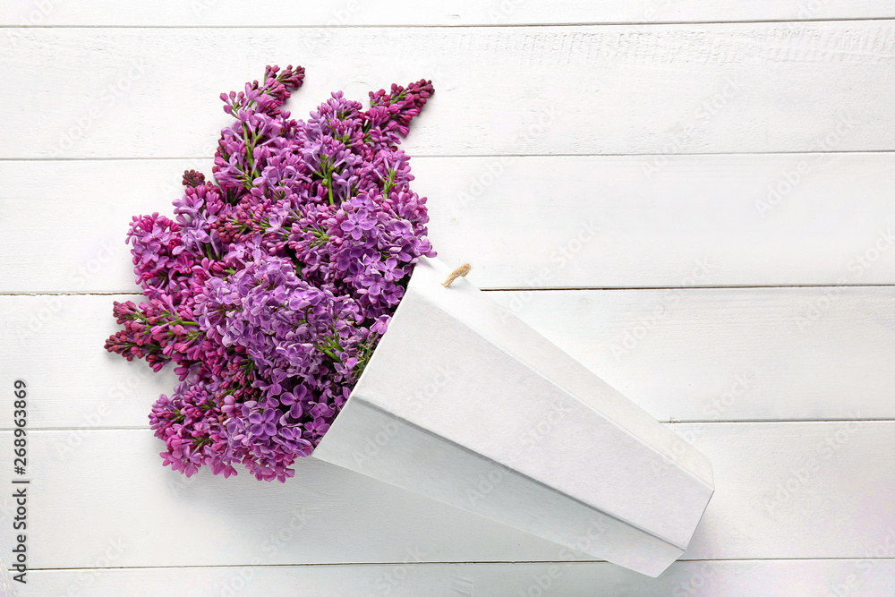 Bouquet of beautiful lilac flowers on white wooden background