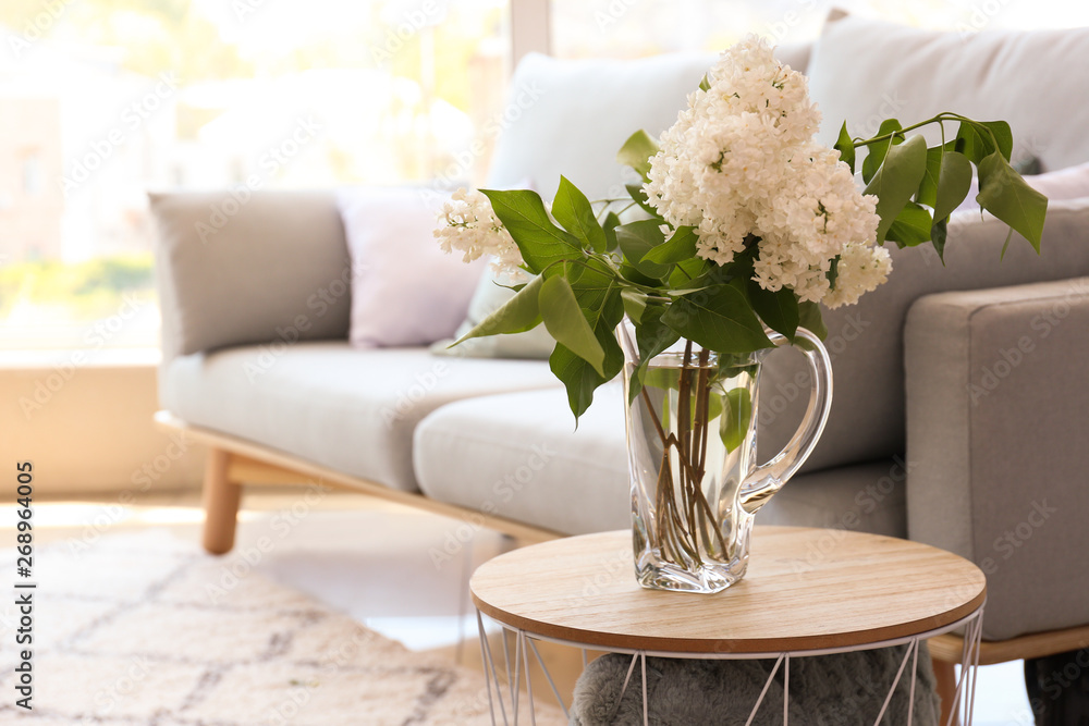 Beautiful lilac flowers on table in room