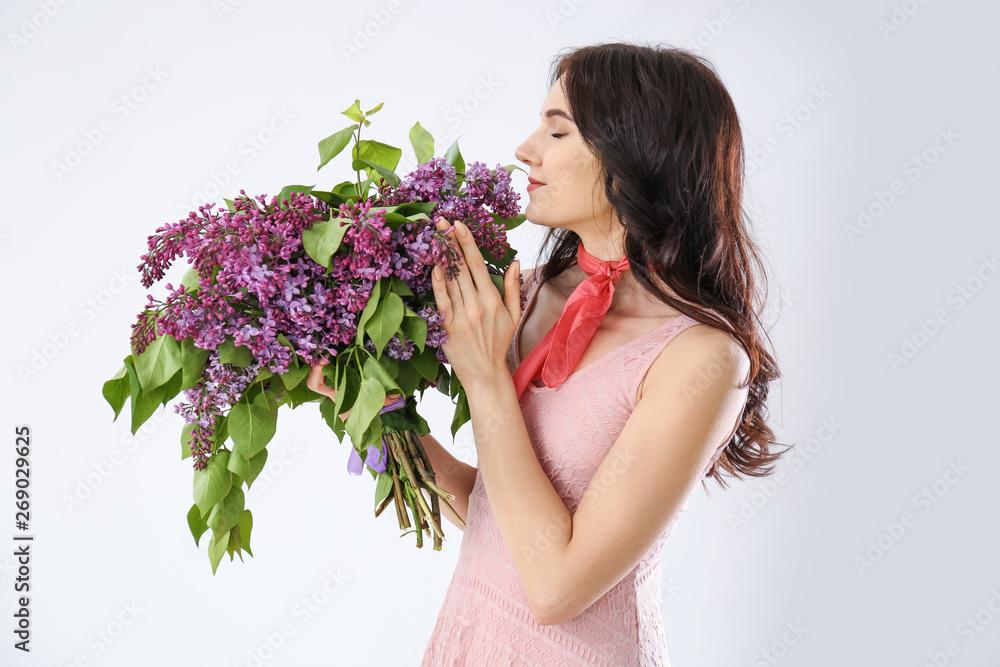 美丽的年轻女子，白色背景上有一束淡紫色的花