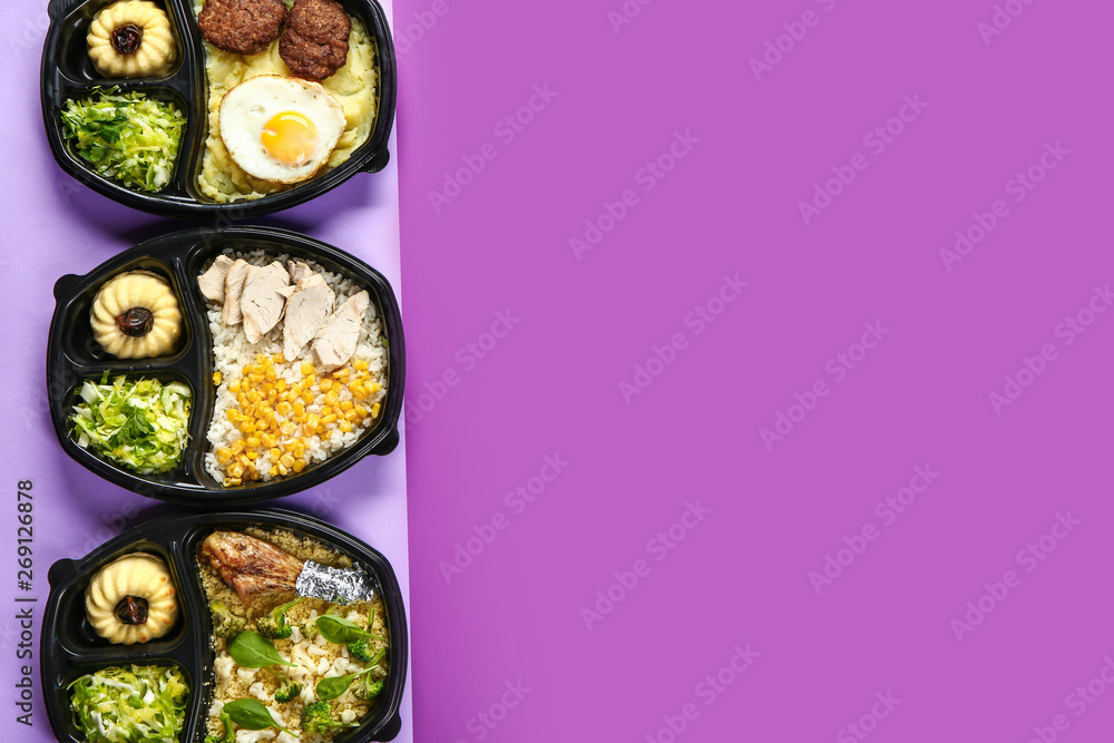 Containers with delicious food on color background