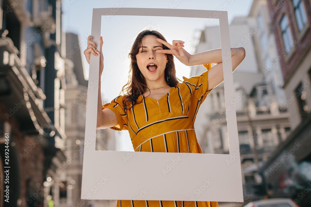 Beautiful woman posing with a frame