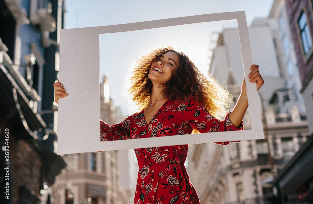 Pretty girl with a large empty frame