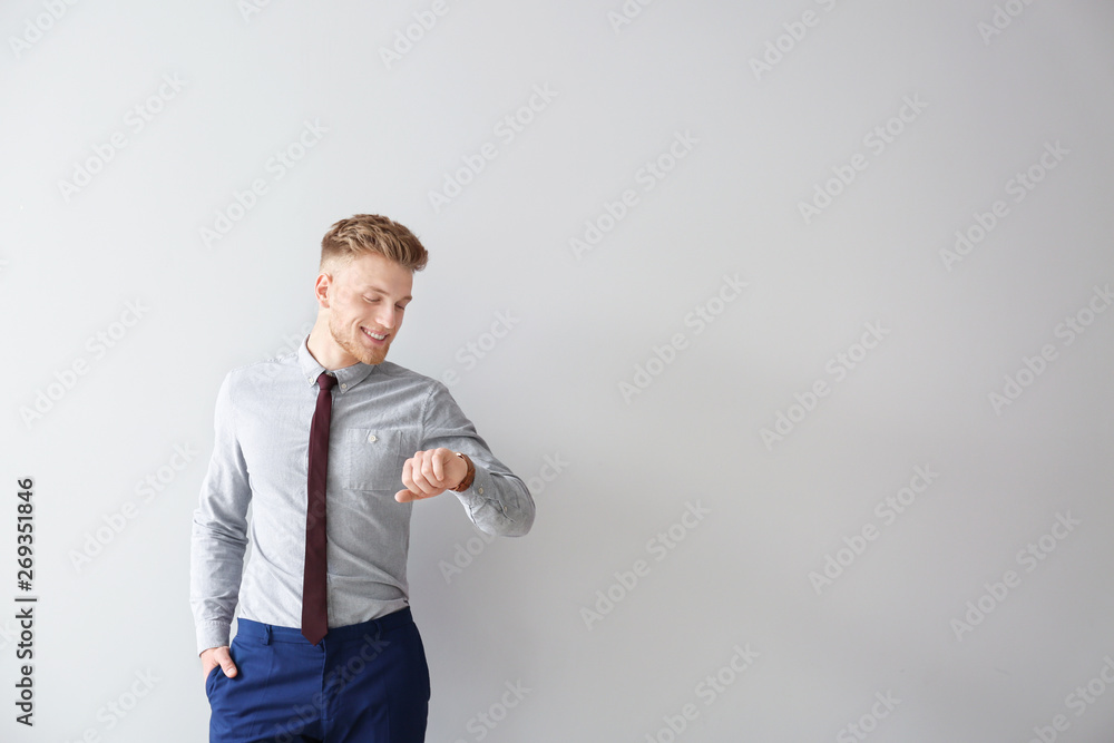 Fashionable young man on grey background