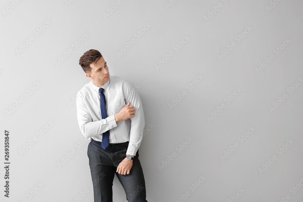 Fashionable young man on grey background