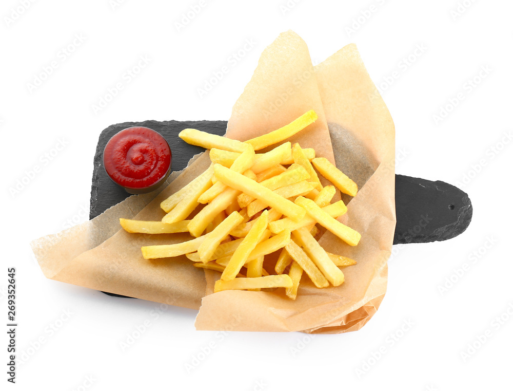 Slate board with tasty french fries and tomato sauce on white background