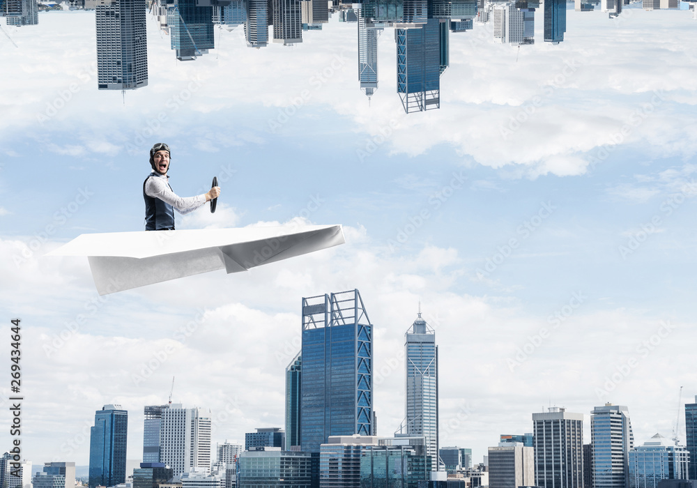 Businessman flying in paper plane