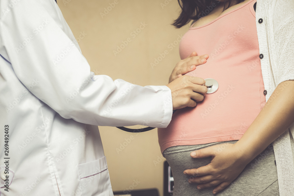 Happy pregnant woman visit gynecologist doctor at hospital or medical clinic for pregnancy consultan