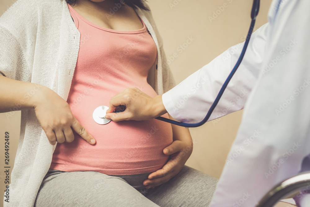 Happy pregnant woman visit gynecologist doctor at hospital or medical clinic for pregnancy consultan