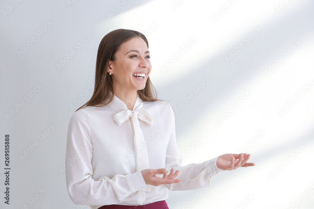 Stylish businesswoman on light background