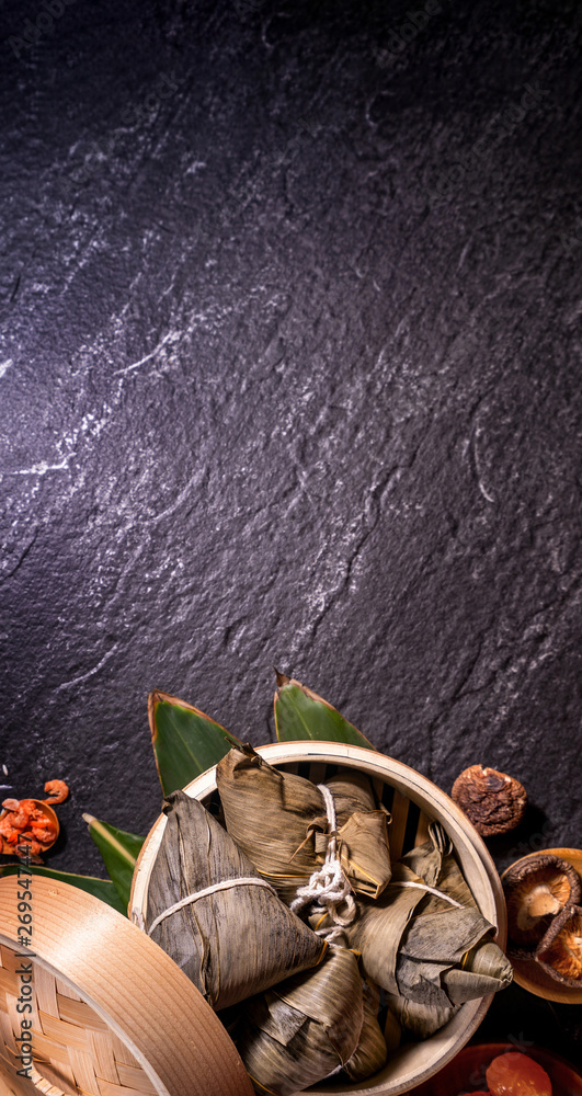 Zongzi, delicious steamed rice dumplings in steamer in black background for dragon boat duanwu festi