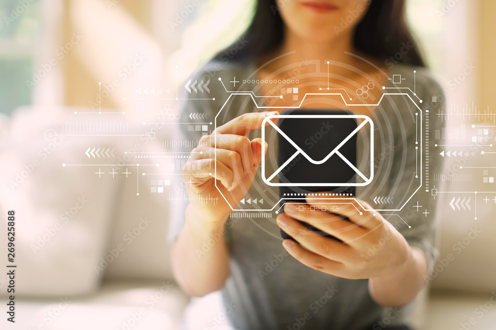 Email with woman using her smartphone in a living room