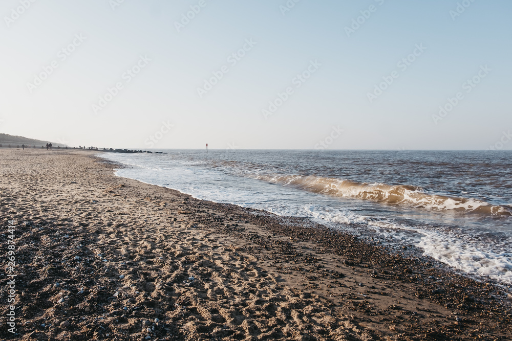 Horsey Gap beach, Norfolk, UK, silhouettes of unidentifiable people on horizon.