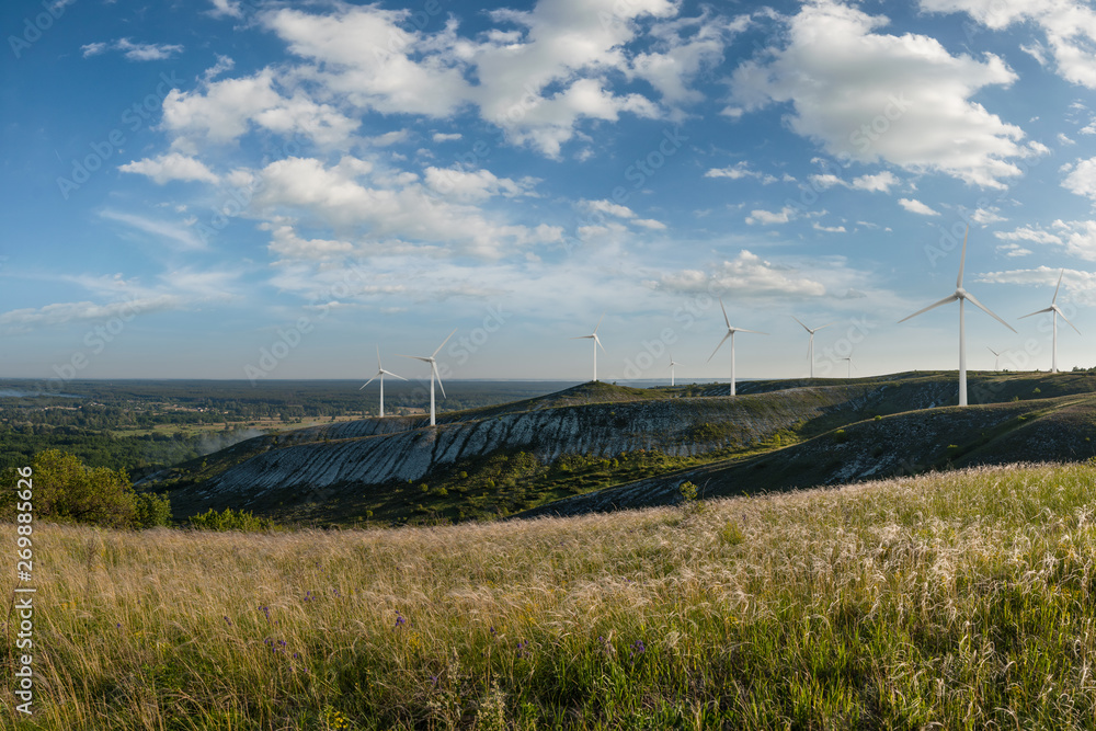 Wind electric turbines on hills