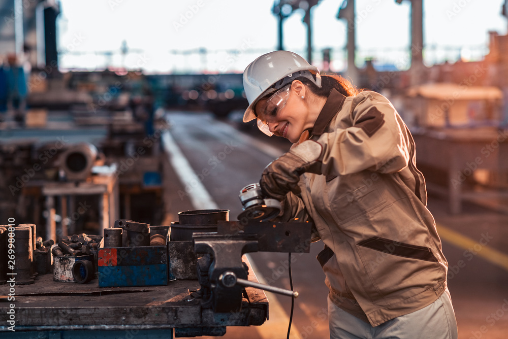 Beautiful woman working at heavy industry factory.