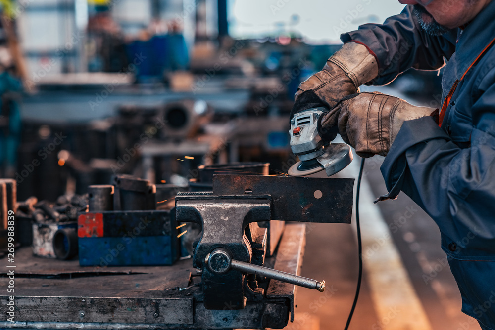 Working in metal industry workshop, close-up.