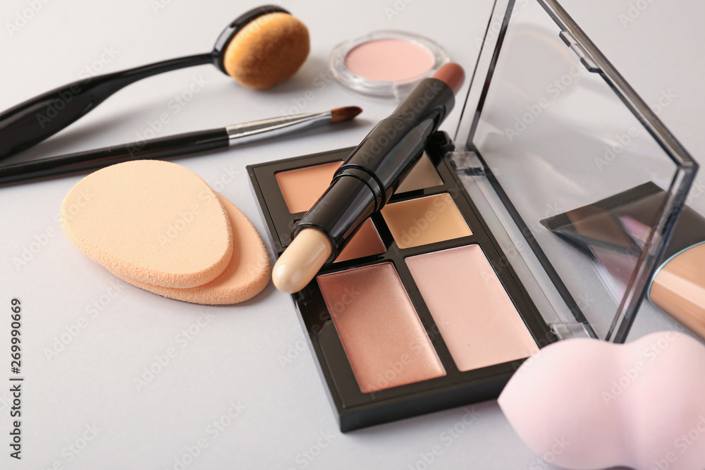 Set of cosmetics for contouring makeup on white background