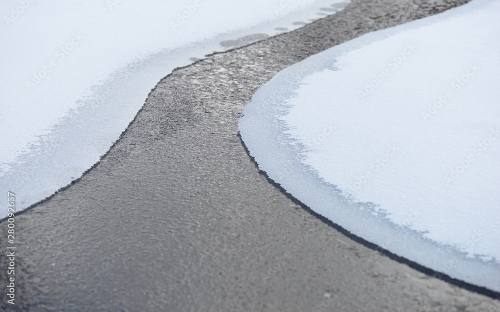 Sparse image of river with edges of melting ice