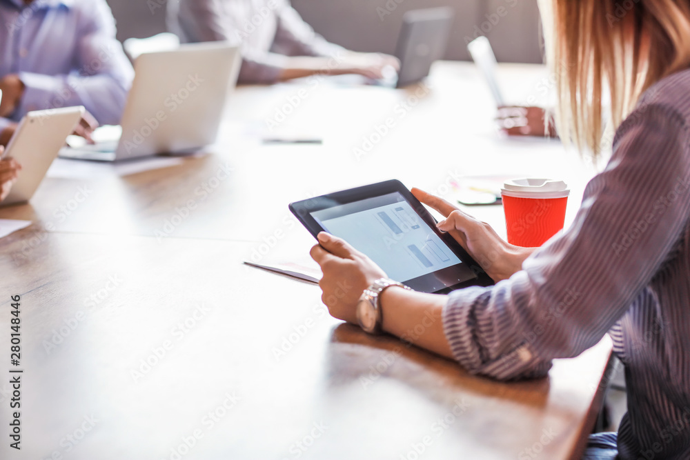 Businesswoman working on tablet PC in office