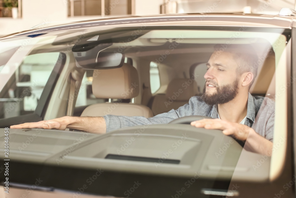 Man choosing new car in salon