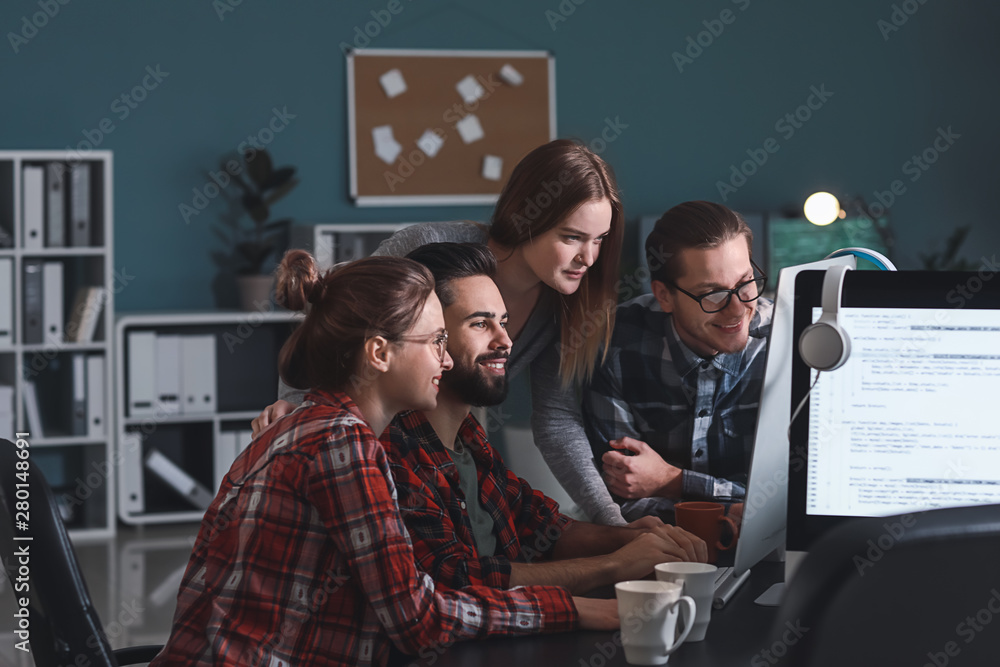 Team of programmers working in office