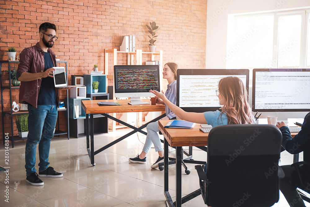 Team of programmers working in office