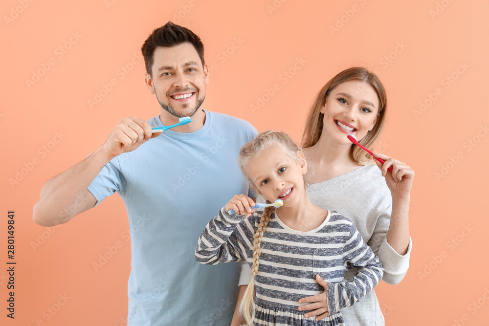 Family cleaning teeth on color background