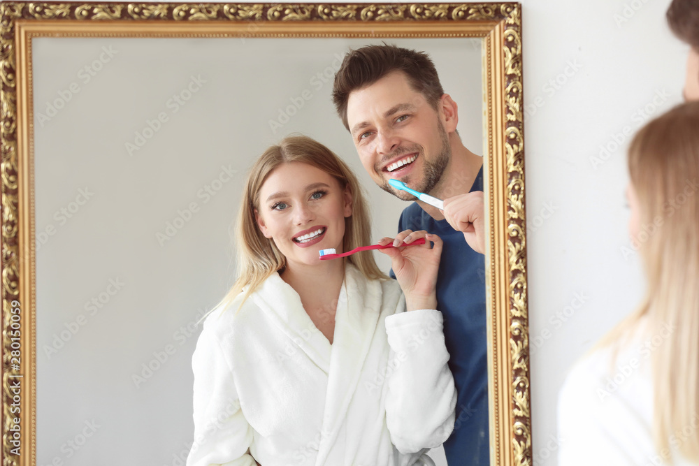 Couple cleaning teeth at home