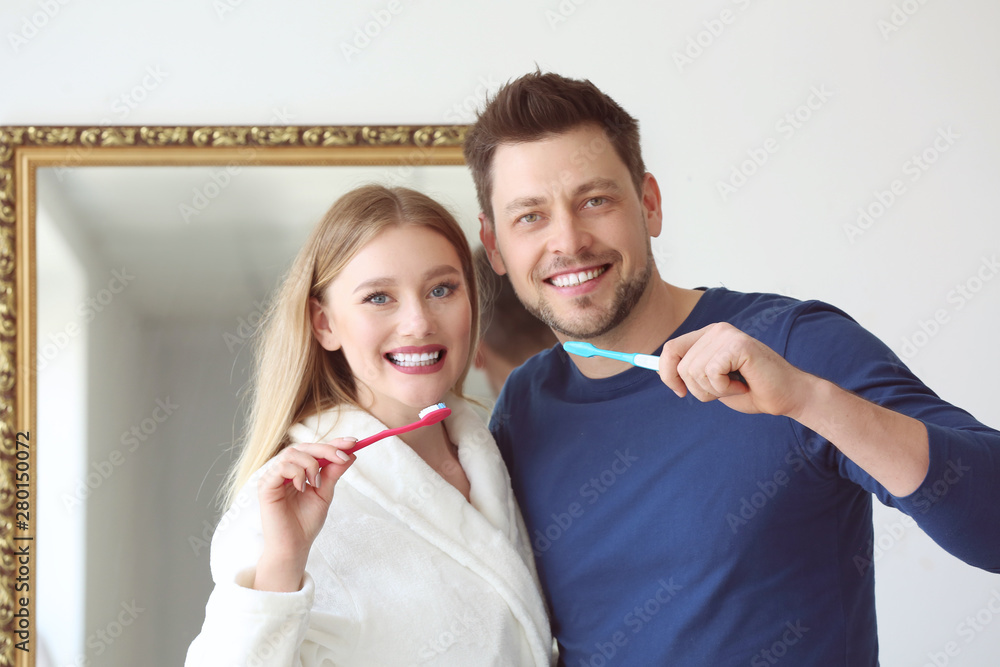 Couple cleaning teeth at home