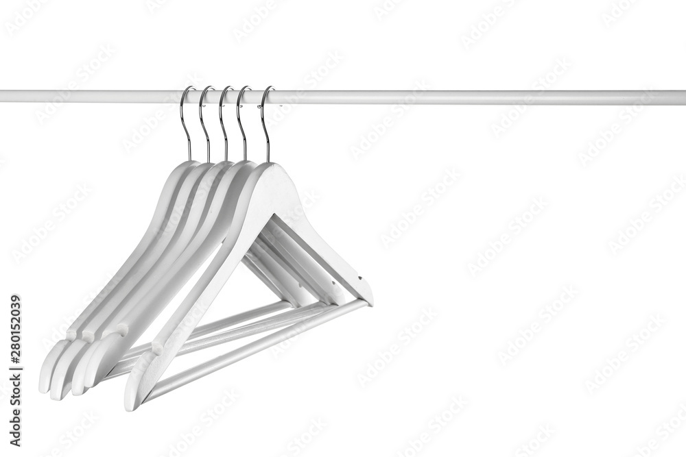 Rack with clothes hangers on white background