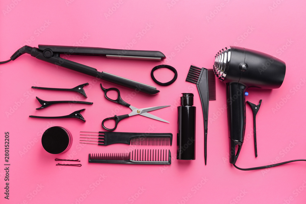 Set of hairdresser tools and accessories on color background